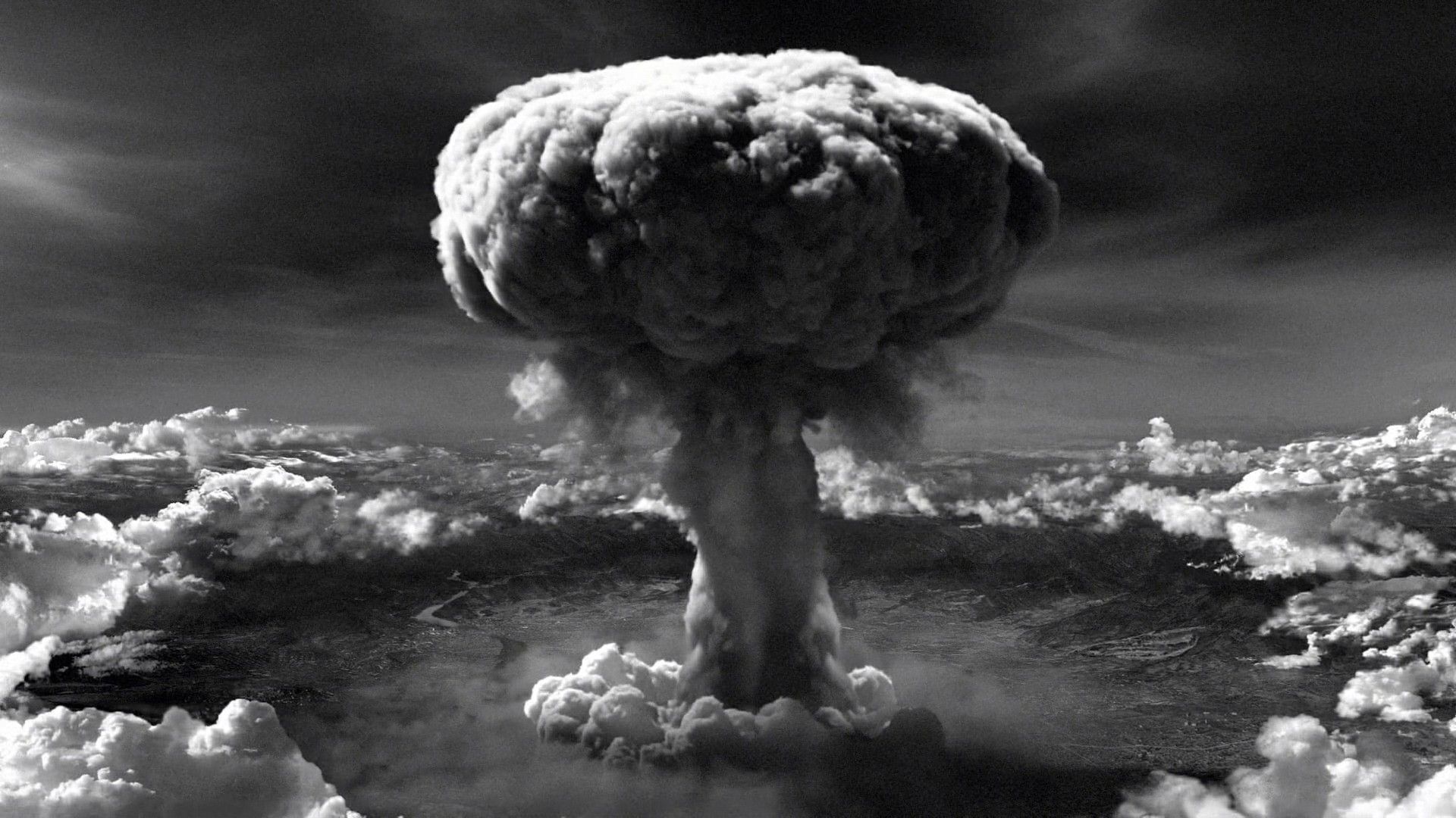 mushroom cloud rises over atomic bombing of hiroshima and nagasaki