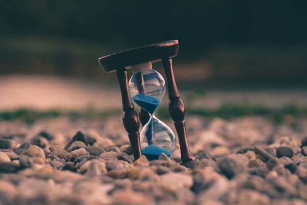 Hourglass on pebbles